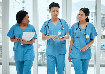 Buy stock photo Teamwork, discussion or nurses walking with tablet planning strategy in hospital in collaboration together. Leadership, doctors or surgeons talking or speaking of healthcare research or digital news