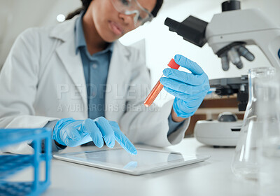 Buy stock photo Shot of a scientist holding a sample while using a digital tablet