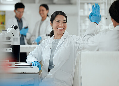 Buy stock photo Shot of two scientists high fiving one another