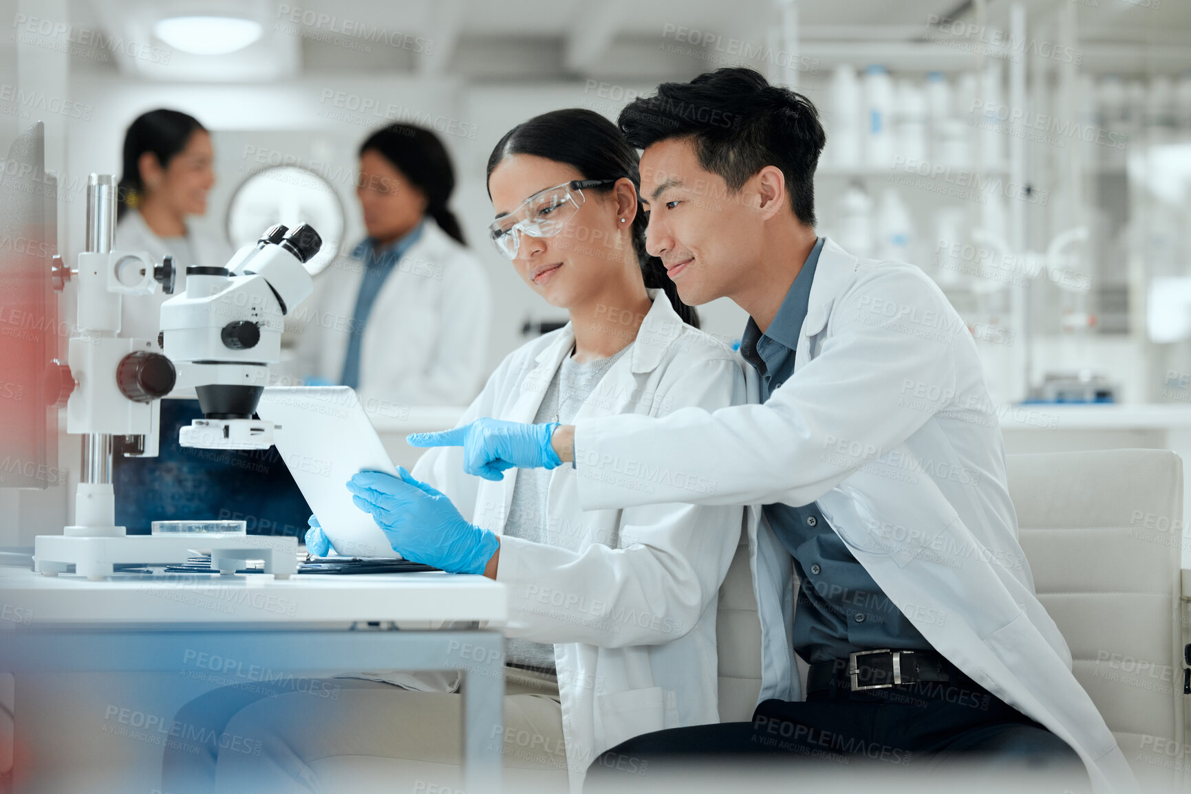 Buy stock photo Research team, tablet and science in lab for healthcare, medicine development and innovation. Scientist, people or technology at microscope for analysis, investigation or planning engineering process