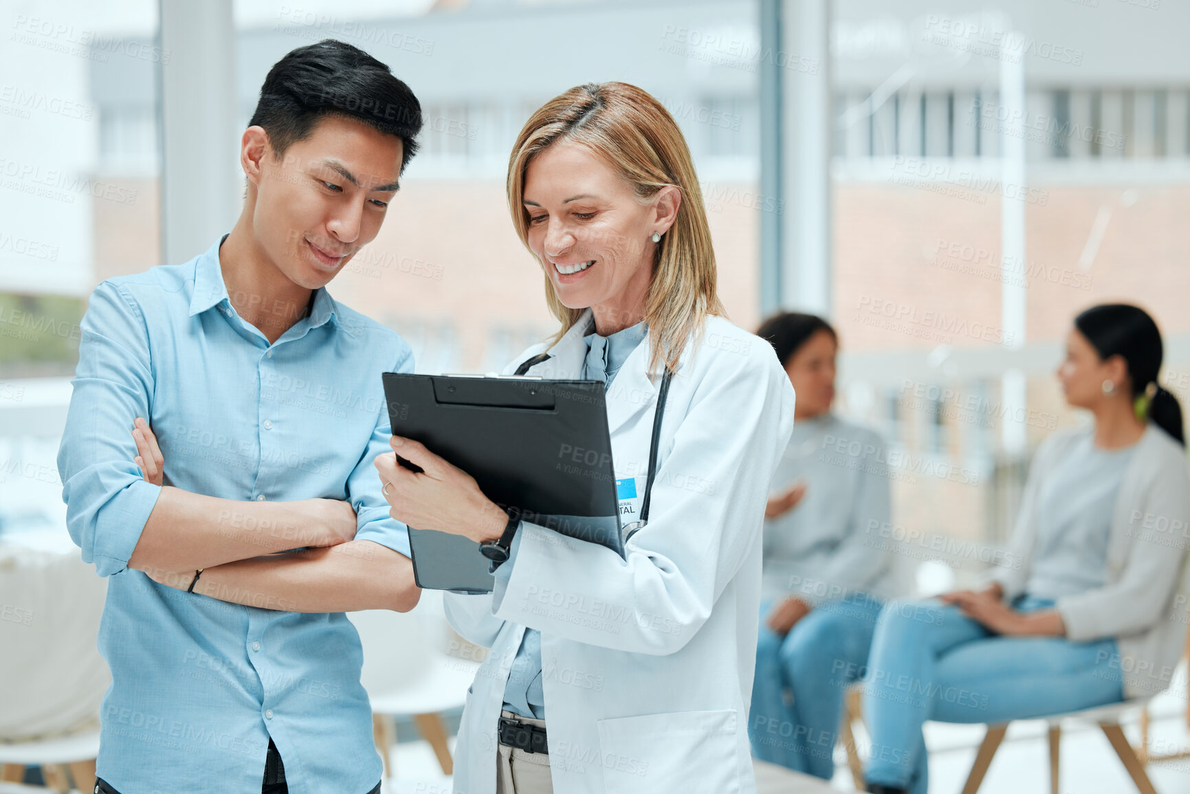 Buy stock photo Shot of a mature doctor and her patient discussing his latest results in the waiting room