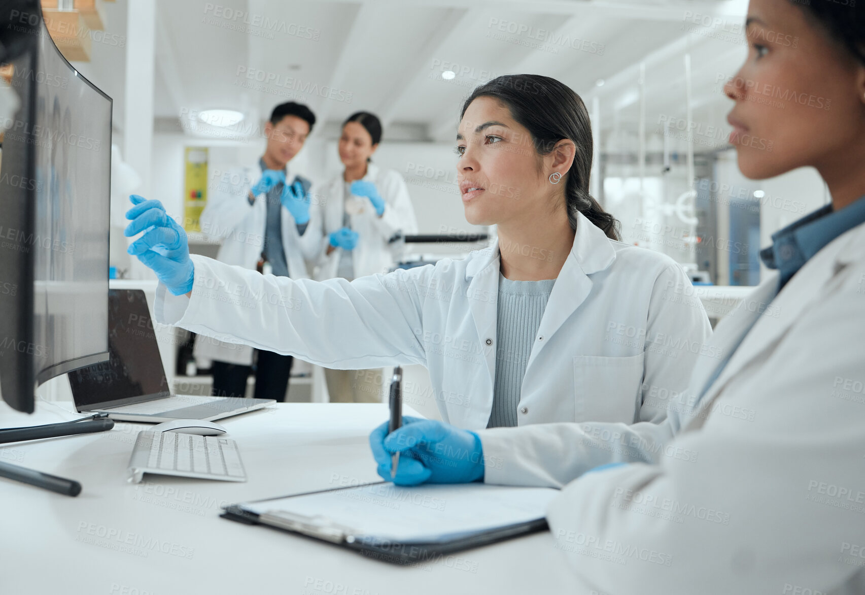 Buy stock photo Shot of two scientists helping one another in the lab