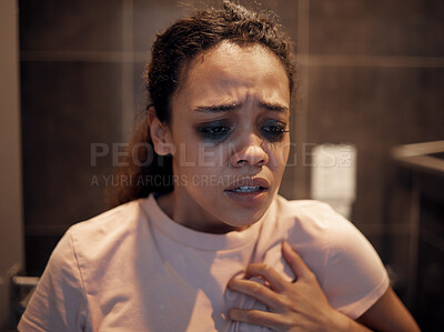 Buy stock photo Shot of a young female experiencing internal turmoil in the bathroom at home