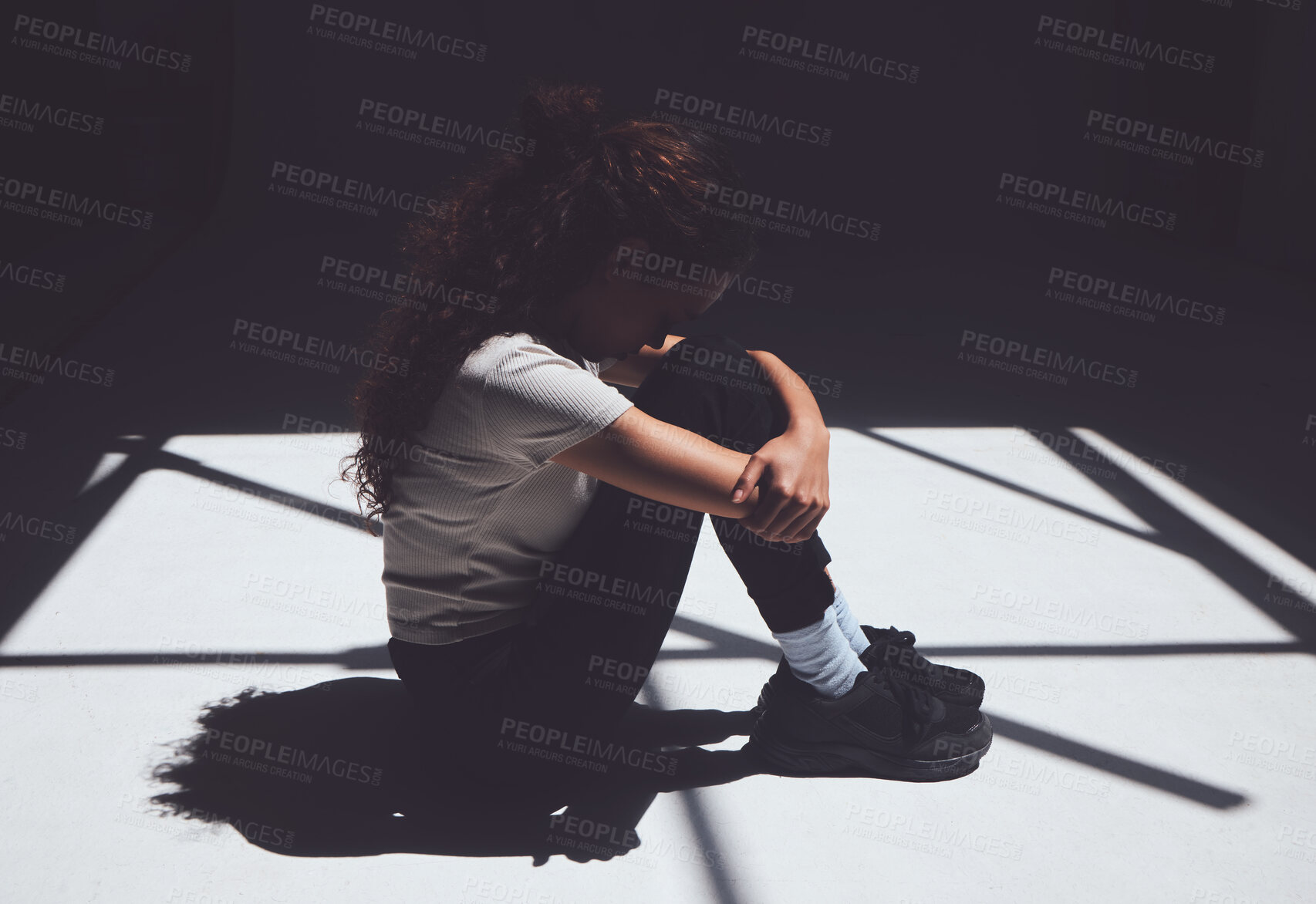 Buy stock photo Woman, depressed and floor sitting with mental health, comfort and ptsd in healthcare institution. Trauma, stress and sad patient with bipolar, anxiety or mood disorder with shadow and lonely