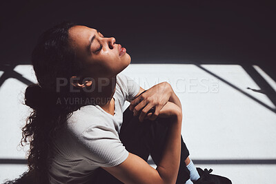 Buy stock photo Mental health, sad woman sitting and isolated in room with tears on her face. Anxiety or depression, psychology or trauma patient and insomnia or depressed scared young female person sit alone 