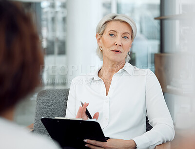 Buy stock photo Shot of a mature psychologist sitting with her patient and using a clipboard during the consultation