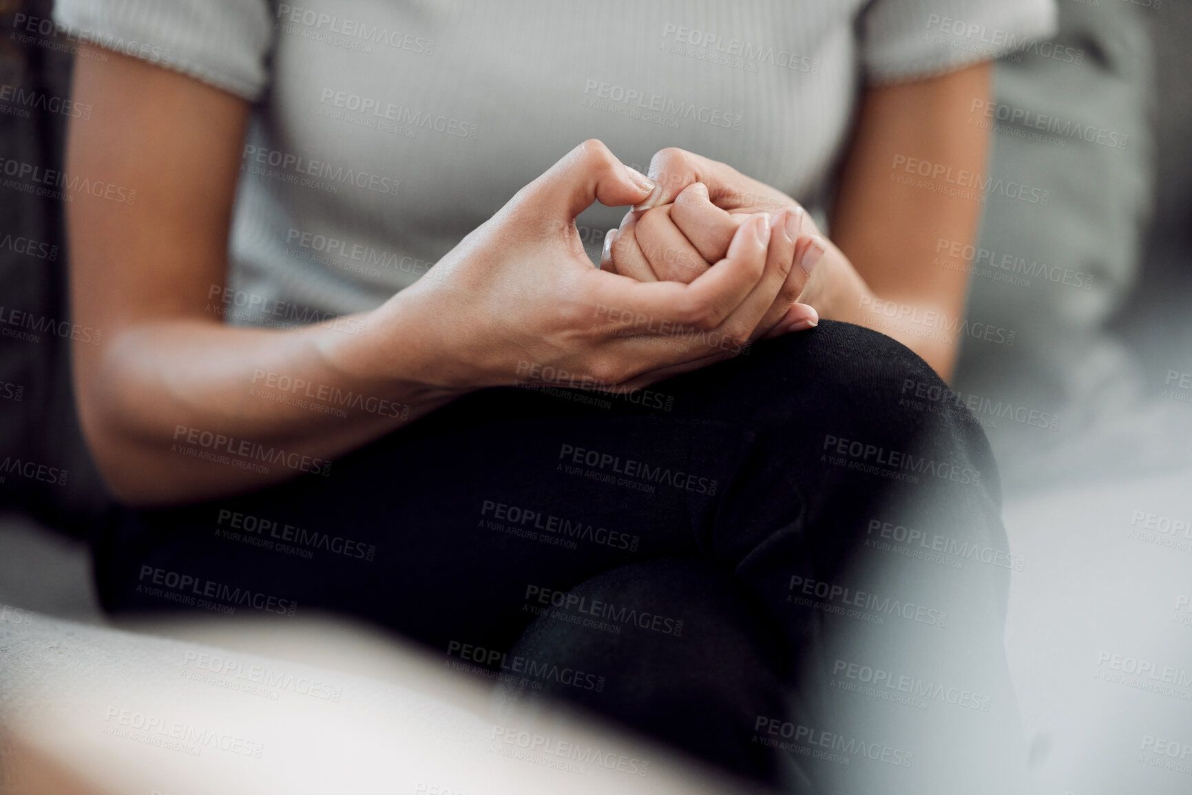 Buy stock photo Cropped shot of an unrecognisable woman sitting alone and feeling anxious while picking the skin on her nails