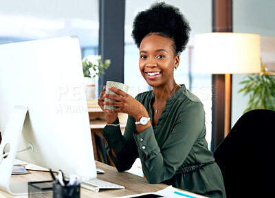 Buy stock photo Shot of a young businesswoman drinking a cup of coffee while using a computer in an office at work