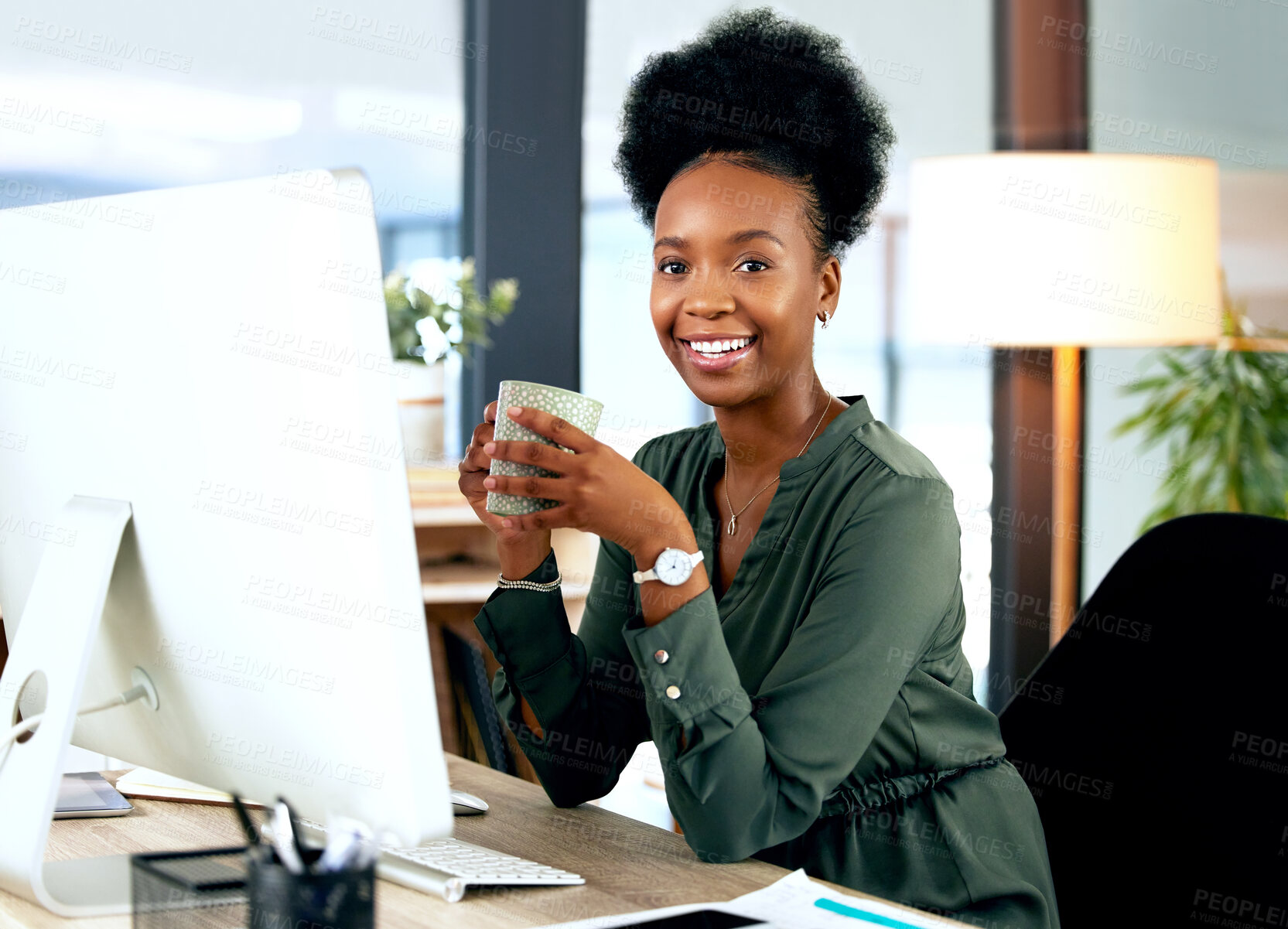 Buy stock photo Shot of a young businesswoman drinking a cup of coffee while using a computer in an office at work