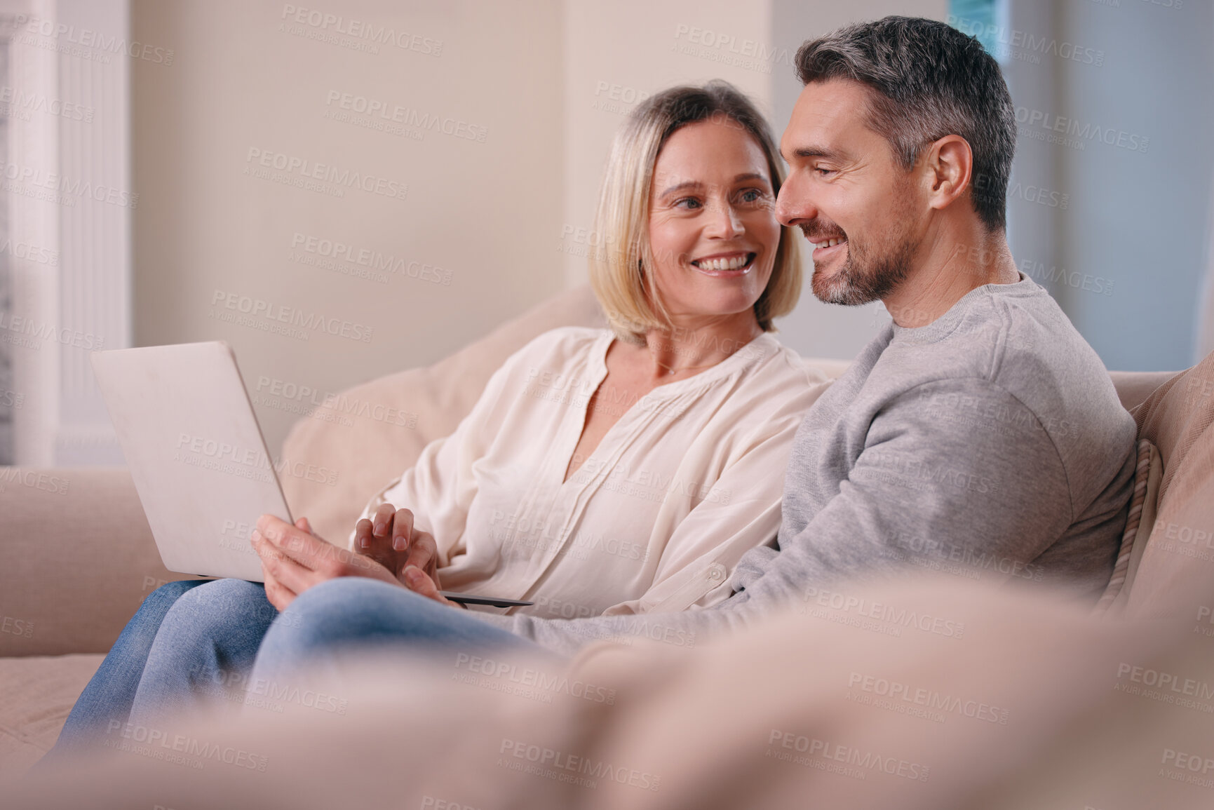 Buy stock photo Shot of a young couple bonding on the sofa at home