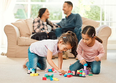 Buy stock photo Shot of a young family bonding inn the lounge at home