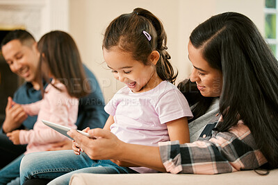 Buy stock photo Shot of a young family bonding inn the lounge at home