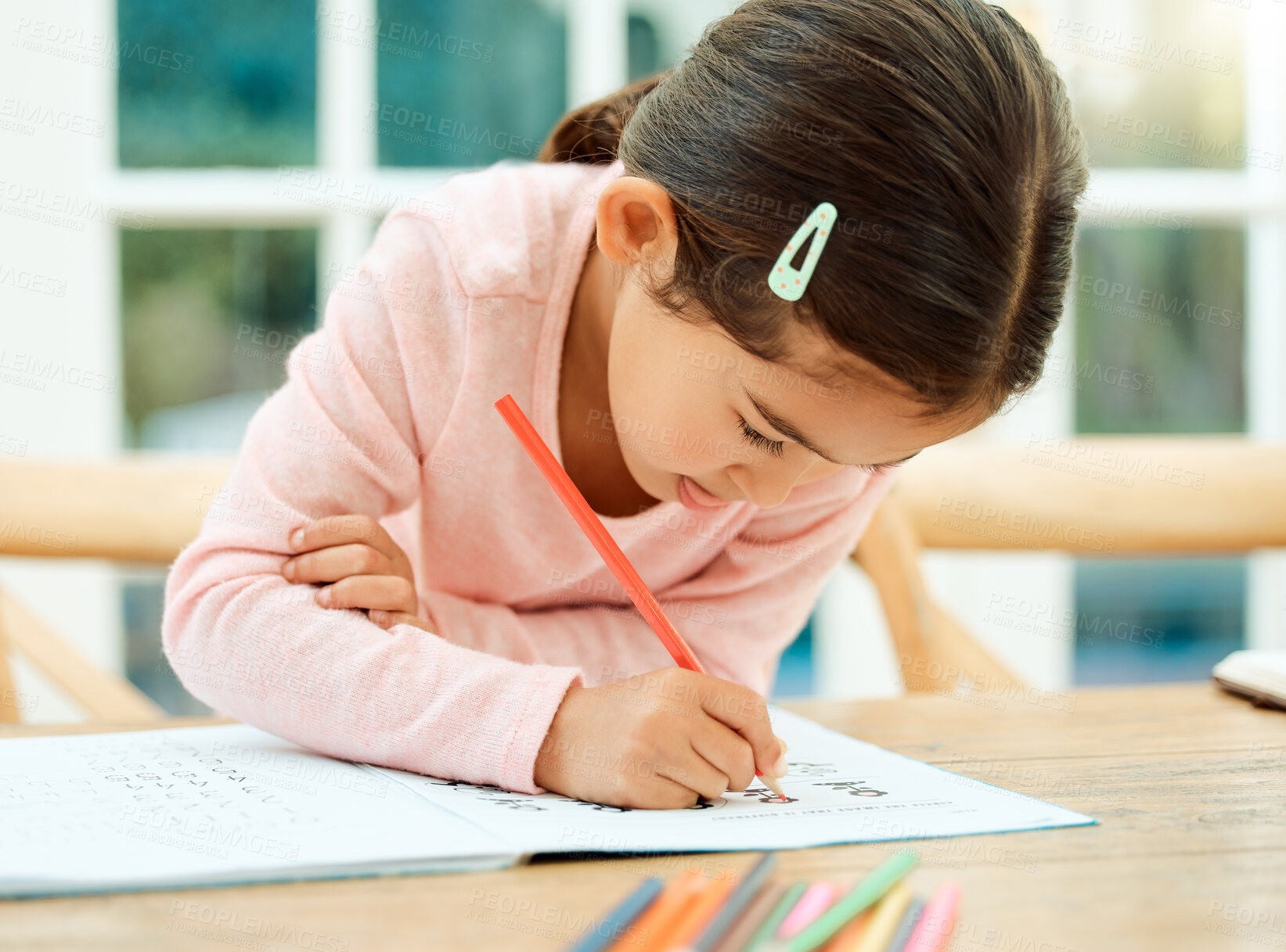 Buy stock photo Thinking, learning and girl with color pencil for creative lesson, motor skills and child development. Happy, home and young kid with crayons for education, fun activity and writing for homework