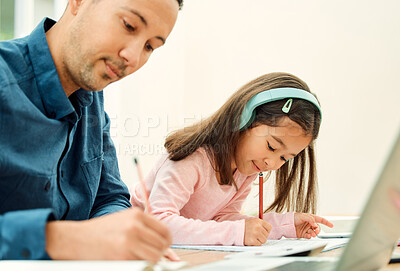 Buy stock photo Cropped shot of an adorable little girl doing her homework next to her dad