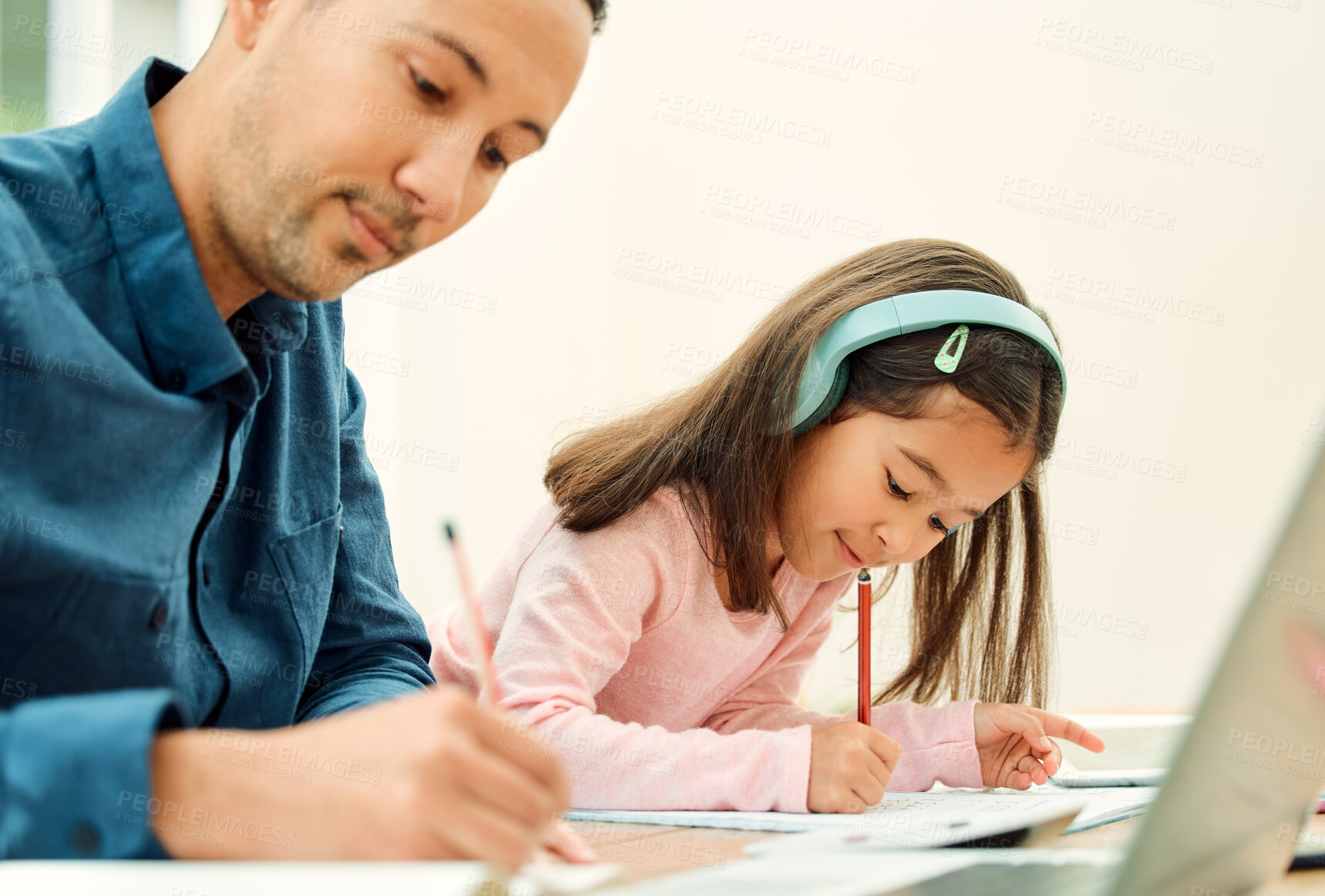 Buy stock photo Cropped shot of an adorable little girl doing her homework next to her dad