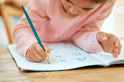 Buy stock photo Cropped shot of an adorable little girl doing her homework