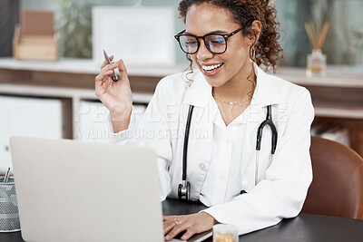 Buy stock photo Cropped shot of an attractive young female doctor working at her desk in the office