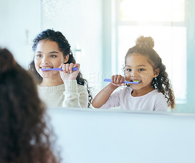 Buy stock photo Mom, girl and brushing teeth in mirror or bathroom for dental care, oral health and teaching for development. Mother, child and reflection in family home for morning routine, hygiene and wellness.