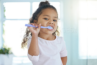 Buy stock photo Girl, brushing teeth and portrait for hygiene, clean mouth and fresh breath for oral care and dental health. Child, cleaning and toothpaste with toothbrush, bathroom and wellness in family home