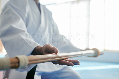 Buy stock photo Cropped shot of an unrecognizable martial artist practicing bojutsu in his dojo