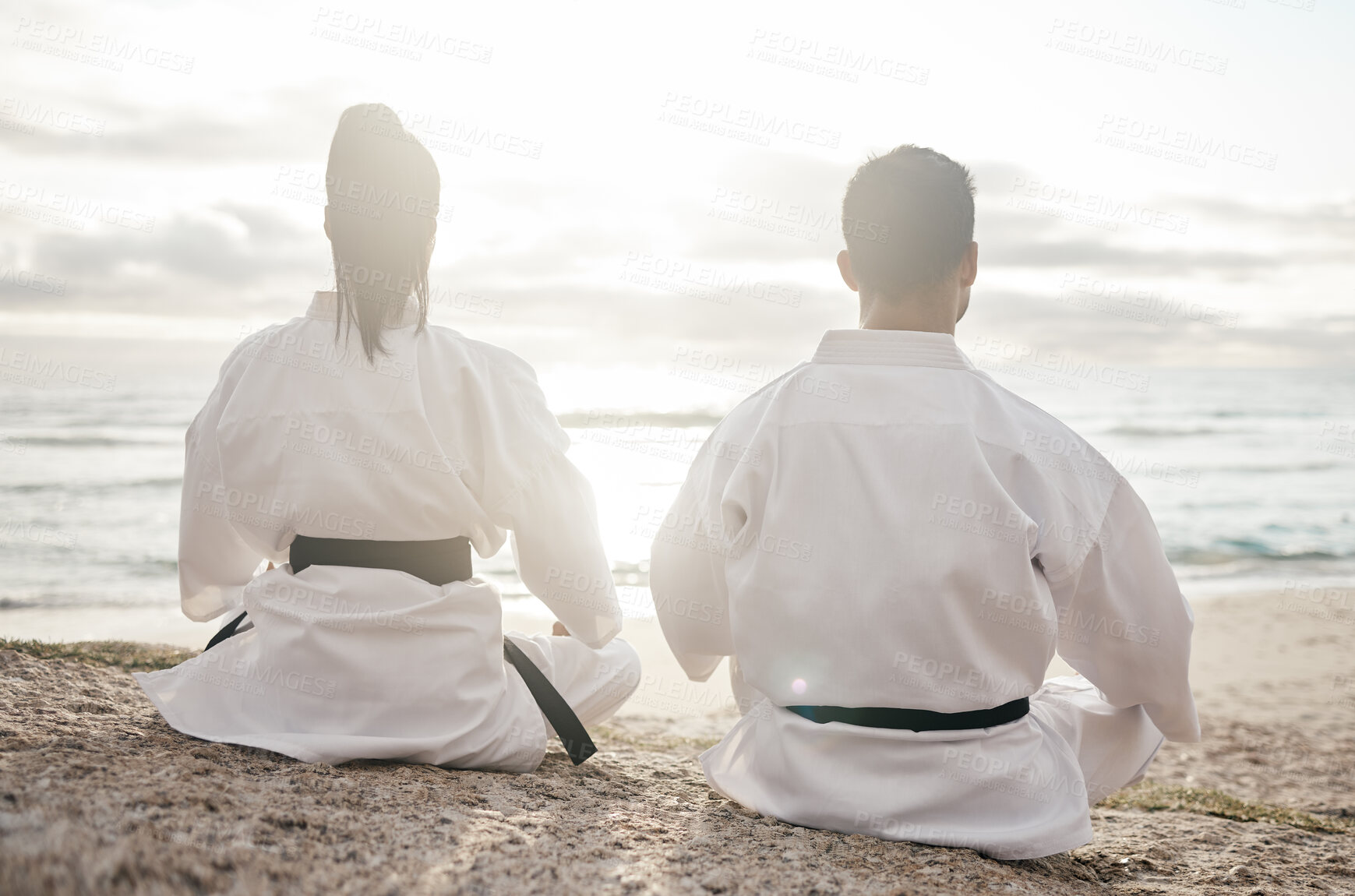 Buy stock photo Beach, karate and couple with training, back and fitness with martial arts, meditation and practice. Motivation, outdoor and ocean with man, wellness and lens flare with exercise, calm and balance