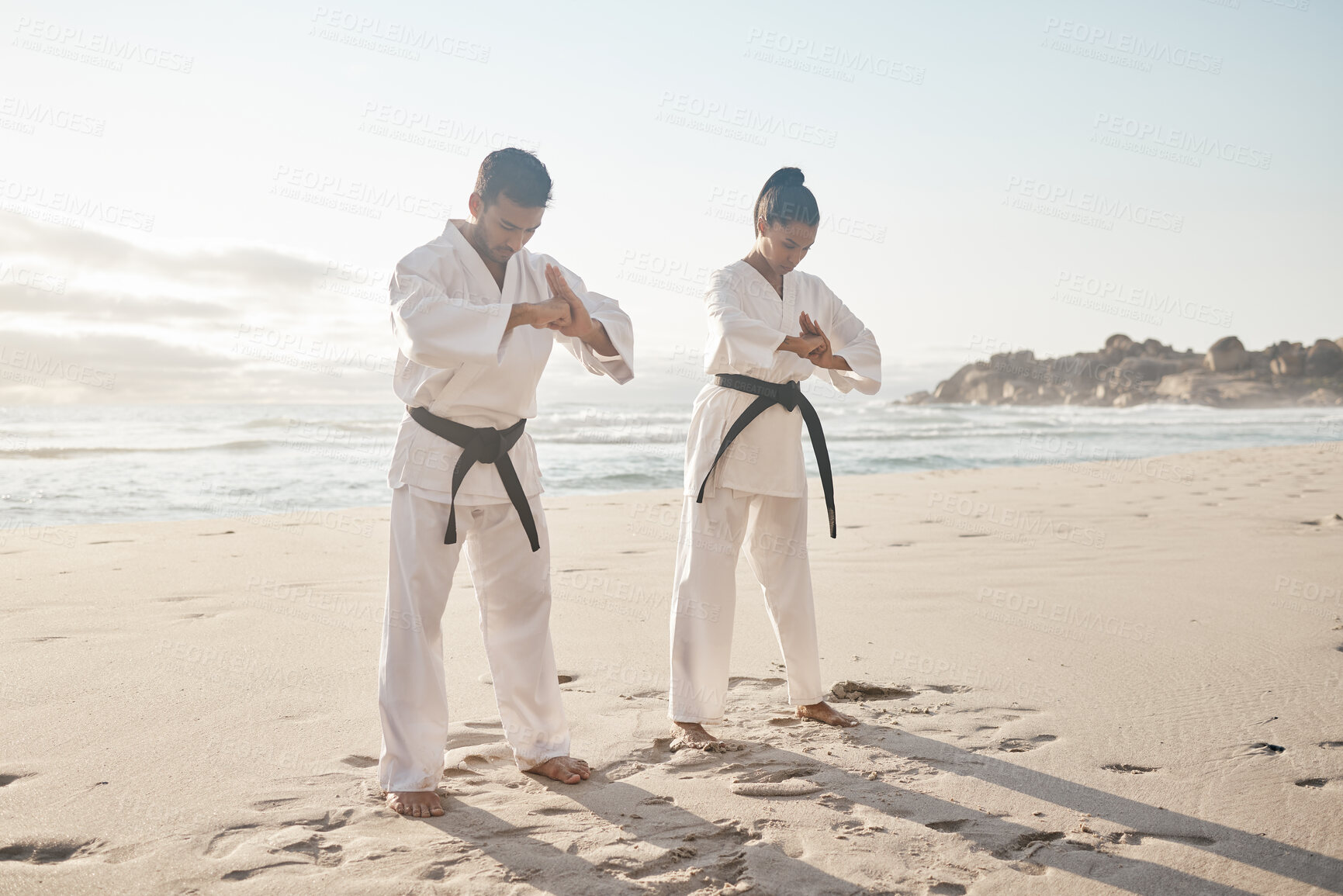 Buy stock photo Beach, karate and couple with training, bow and fitness with martial arts, uniform and practice. Motivation, outdoor and ocean with man, wellness and respect with exercise, honor and balance