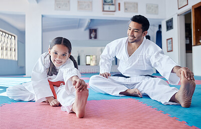 Buy stock photo Shot of a young man and cute little girl practicing karate in a studio