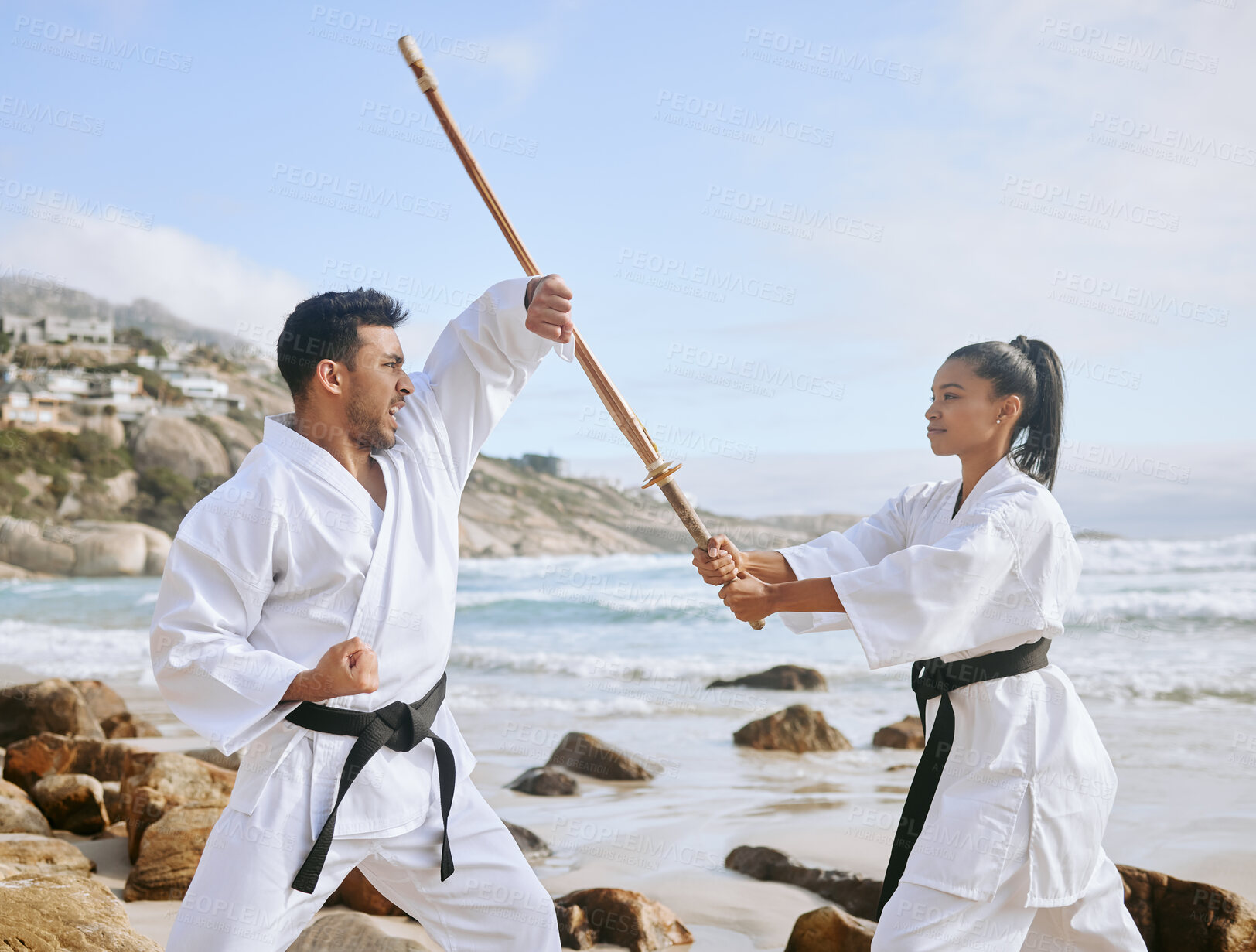 Buy stock photo Martial arts, practice sword and people training at beach for fitness, fight and block attack. Karate, man and woman with wood shinai for exercise with teacher and samurai at ocean outdoor in summer