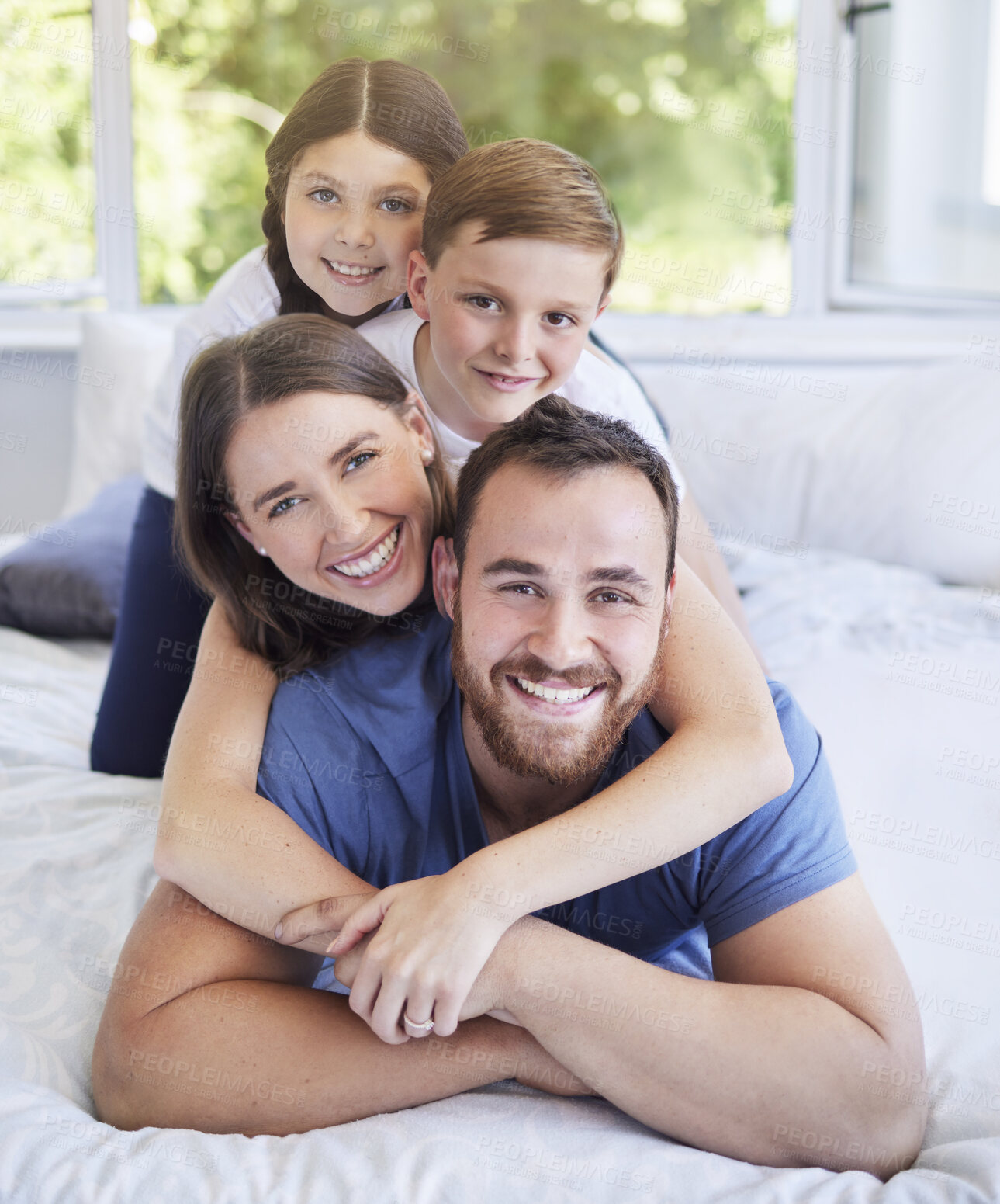 Buy stock photo Happy family, portrait and bed with hug for bonding, holiday or weekend together at home. Mother, father and playful children on back with smile for morning, wake up or lying in bedroom at house