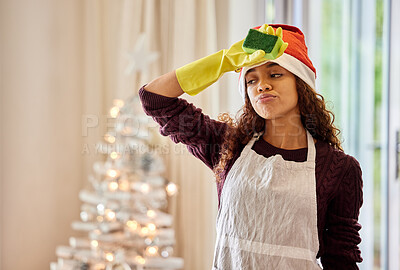 Buy stock photo Shot of a young woman looking tired while cleaning at home