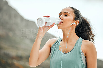 Buy stock photo Break, fitness and a woman with water in nature and music for exercise, cardio and rest from running. Sports, streaming audio and a young athlete with a bottle for a drink after training at a park