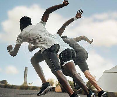 Buy stock photo Shot of a group of men exercising in nature