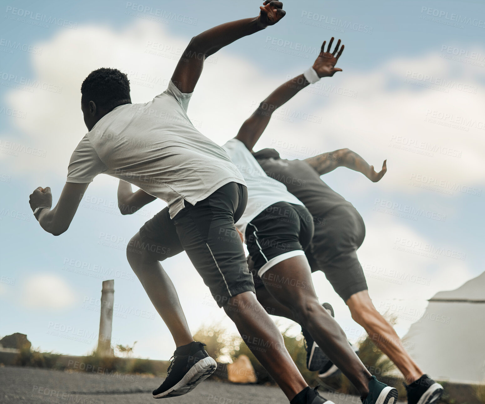 Buy stock photo Shot of a group of men exercising in nature