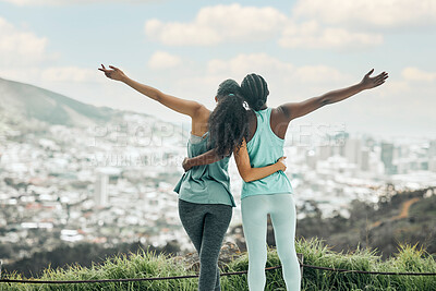 Buy stock photo Shot of two unrecognizable woman enjoying the view on a mountain after a run