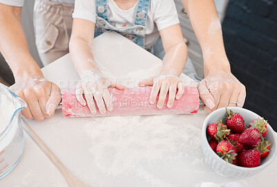 Buy stock photo Shot of a unrecognizable mother and daughter rolling dough in the kitchen