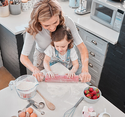 Buy stock photo Shot of a mother and daughter baking in the kitchen at home