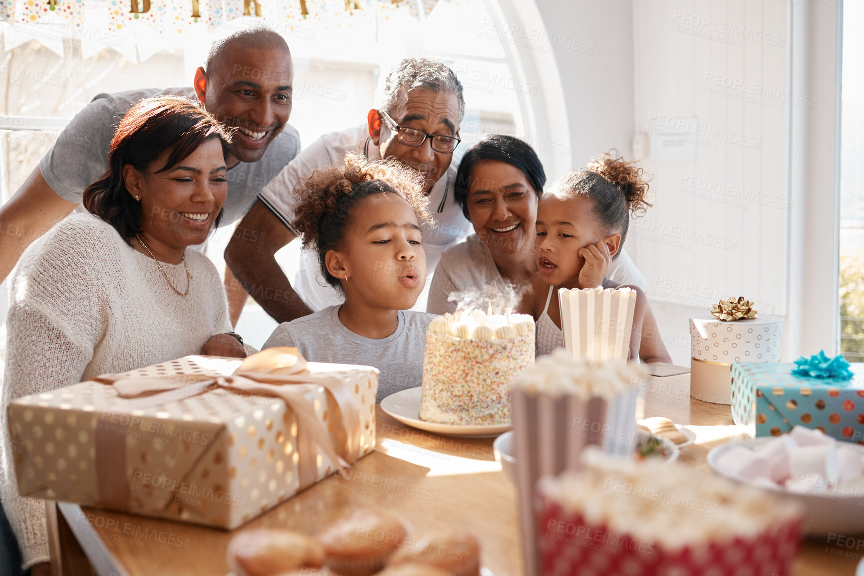 Buy stock photo Happy birthday, celebration and family with child by cake for special day, party and milestone at home. Excited grandparents, people and kid or girl blowing candles with love, appreciation or support