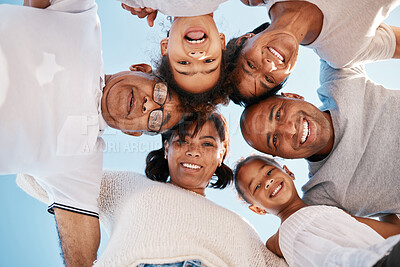 Buy stock photo Low angle shot of a family huddling together outside