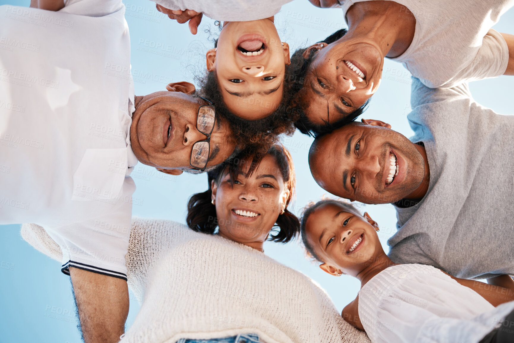 Buy stock photo Sky, portrait and family together in huddle with smile, love and bonding on beach vacation. Men, women and children in circle with solidarity, support and outdoor holiday in Mexico with low angle