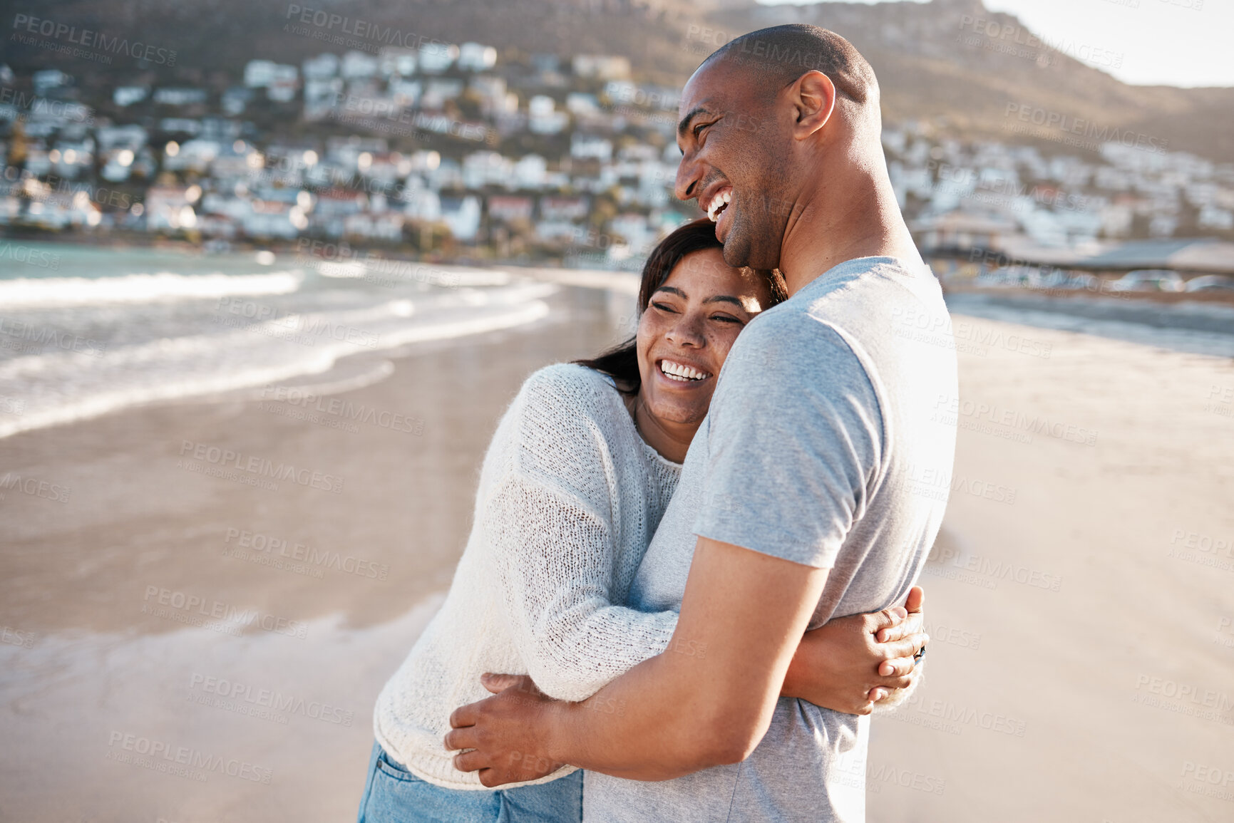 Buy stock photo Couple, hug and laugh in outdoor on beach, romance and bonding for healthy marriage or trust. People, happiness and holiday in nature for relationship, embrace and support for security on island