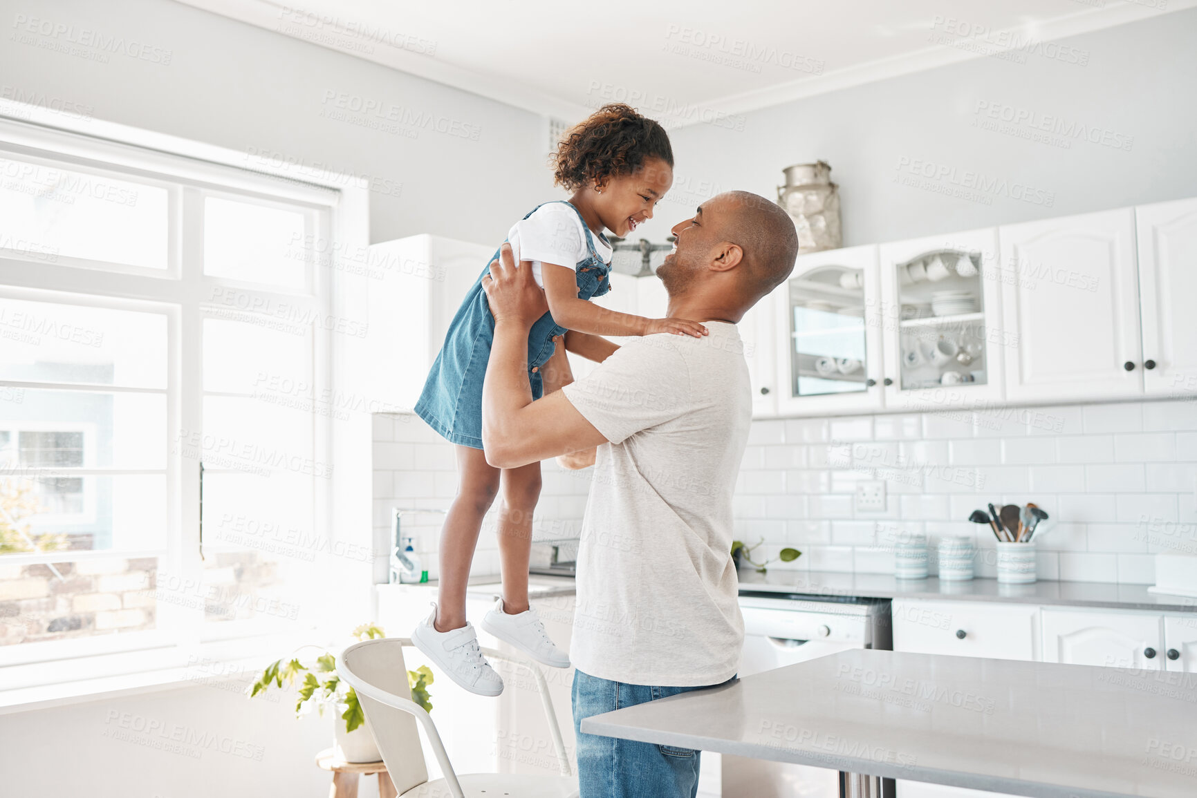 Buy stock photo Hug, dad and girl in home for playing or bonding together and child care with single parent or love. Lifting, wellness and happy father in kitchen with support, security and smile with kid or family