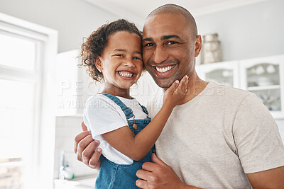 Buy stock photo Shot of a young father and daughter spending time together at home