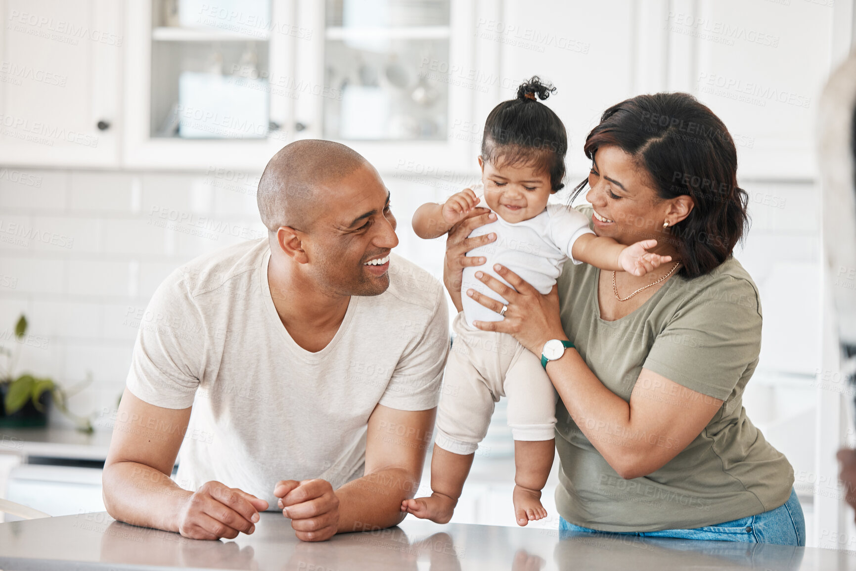 Buy stock photo Mom, dad and baby in kitchen for bonding together and child care with proud parents, father or love. Mother, house and people in kitchen with support, security and smile with girl, trust or family