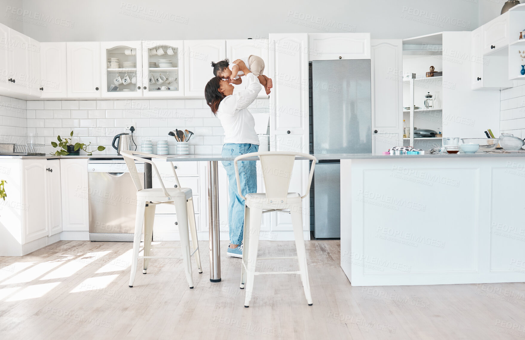 Buy stock photo Hug, mom and girl in home for playing or bonding together and child care with single parent or love. Lifting, wellness and happy mother in kitchen with support, security and smile with kid or family