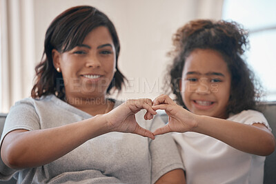 Buy stock photo Shot of a young mother forming a heart shape with her daughter at home