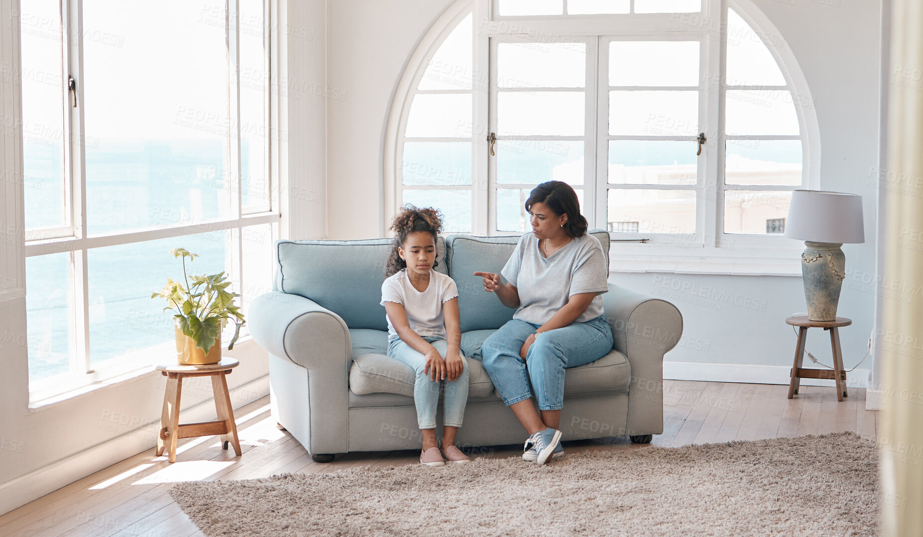 Buy stock photo Shot of a young mother scolding her daughter