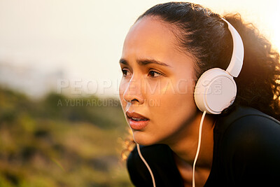 Buy stock photo Shot of a beautiful young woman catching her breathe while having her morning run outside