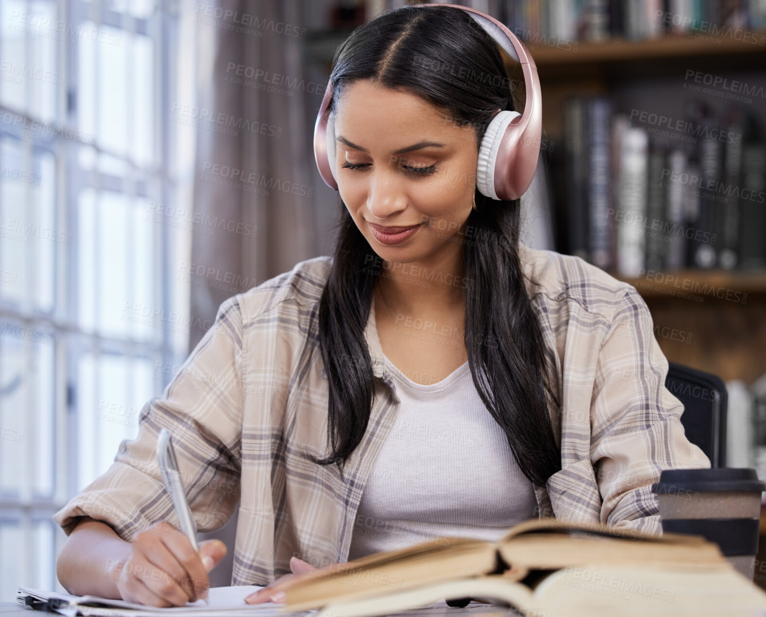 Buy stock photo Headphones, study and girl with notebook in library for music, learning or studying for exam. University, student and writing with technology on table for knowledge, development or streaming of audio