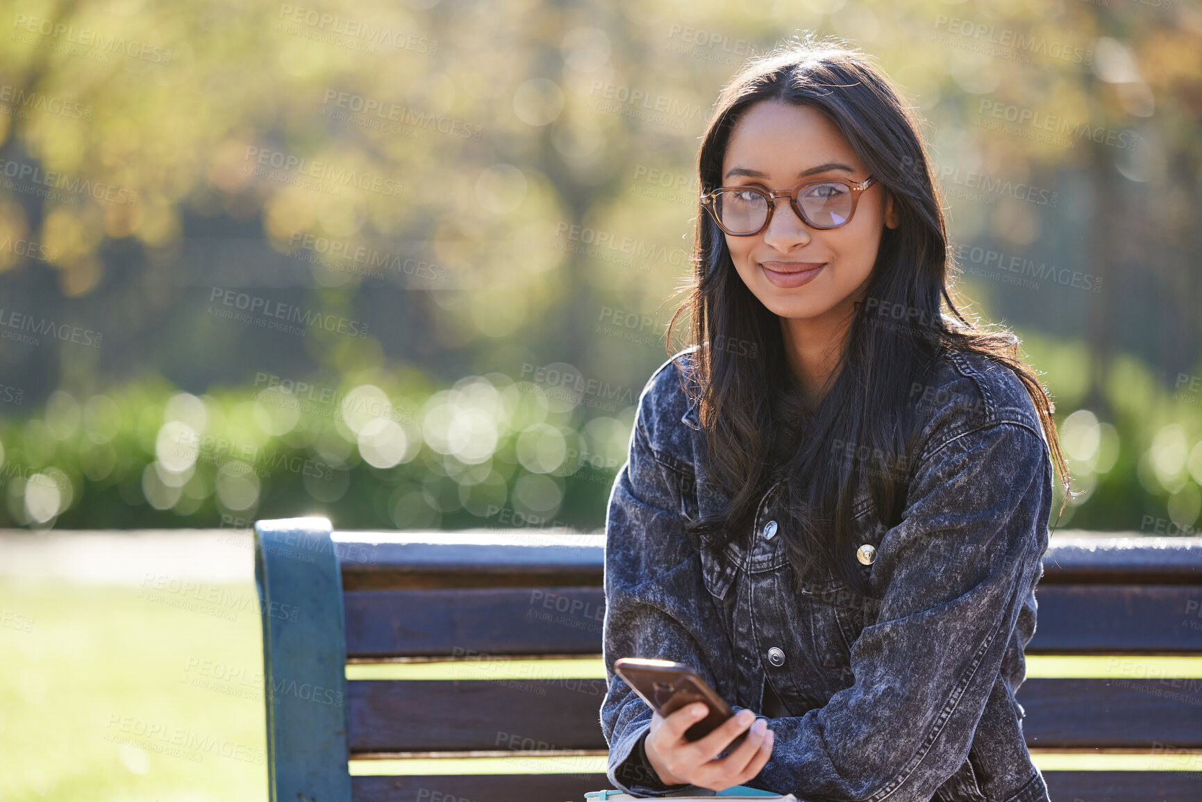 Buy stock photo Portrait, smile and girl on bench, smartphone and relax with social media, internet and connection. Face, person and student in park, cellphone or university with mobile user, website info or message