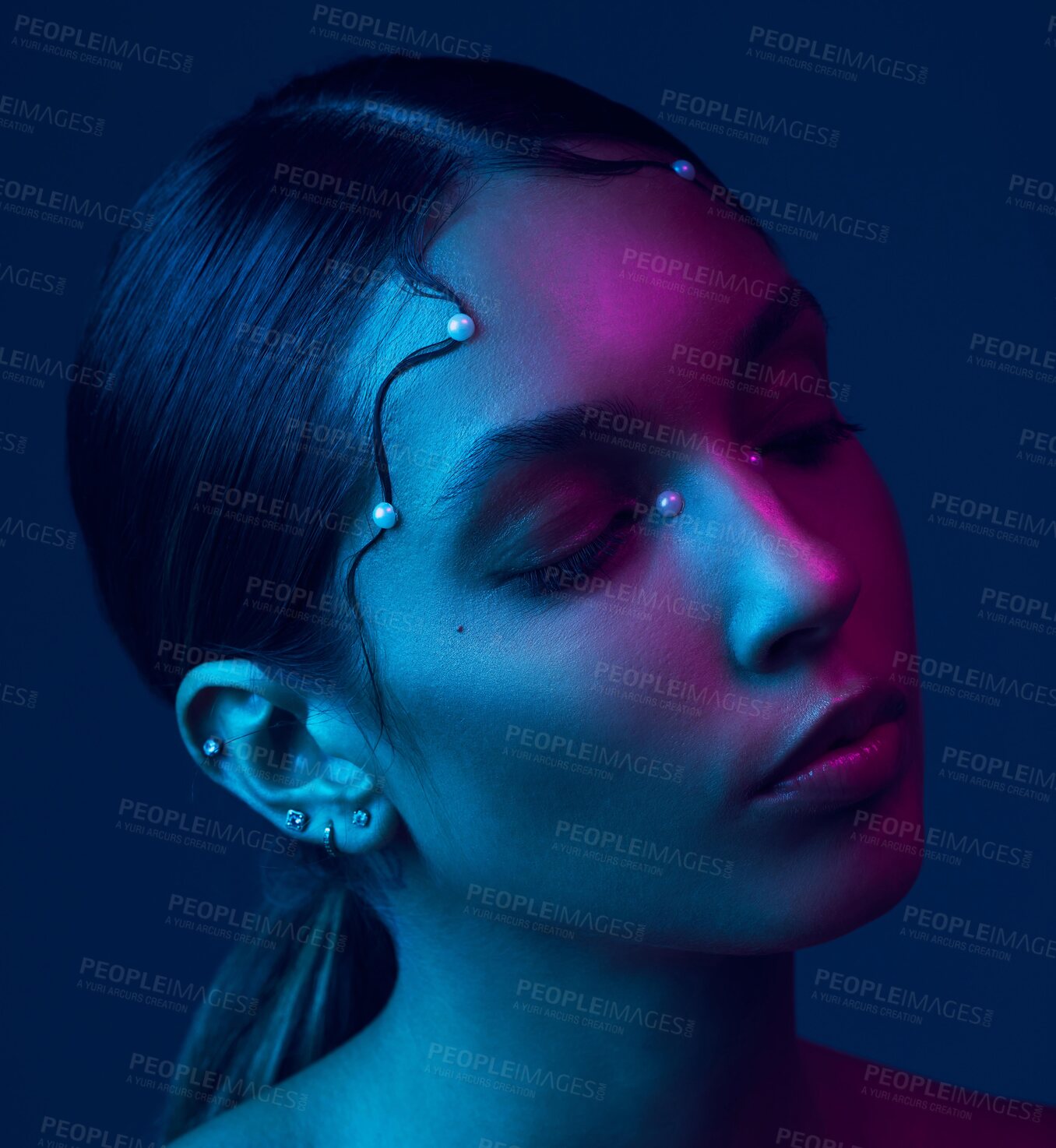 Buy stock photo Cropped shot of an attractive young woman posing in studio against a blue background